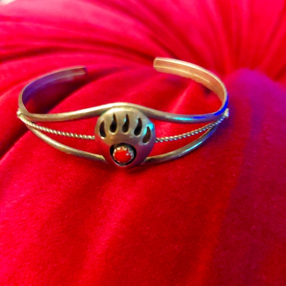 2 western style silver bracelets, one with coral, the other a coral color design